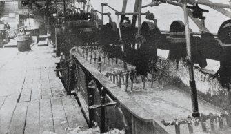Copy of historic photograph showing interior view of wool washing.