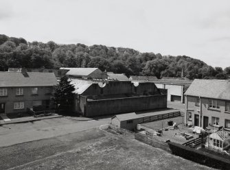 Distant elevated view from NE, showing North-lit roofs covering most of the works