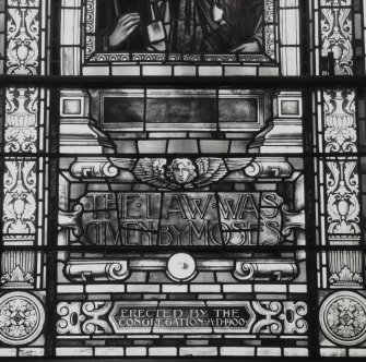 Interior. Stained glass window. Inscription on Moses window Detail
