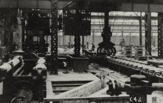 Interior.
View of Pilger Mill, Mandrel Threader, Hollow Bloom Conveyor and Feed Carriage.