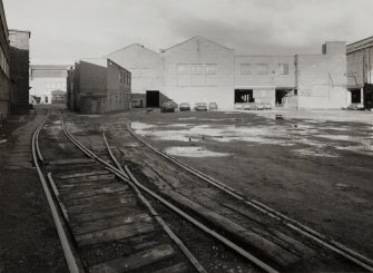 General view from SSE showing internal railway track, Building 34, and (in background) New Foundry, with Offices to left