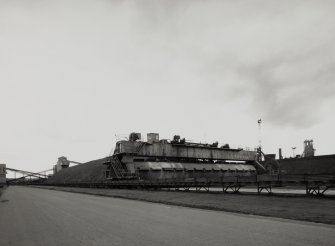 General view of ore bed being gathered by Strachan barrel reclaimer for transport by conveyor to sintering plant, from N.