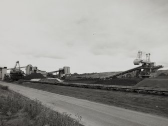 General view of ore stackyard with boom stackers, conveyors and control tower from SW.