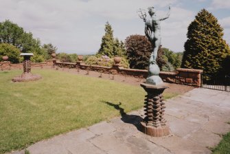 View of Terrace with sundial and statue on brick plinths