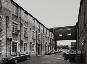 View from SW down yard enclosed by main multi-storeyed blocks of the works.  Photosurvey 23-APR-1992