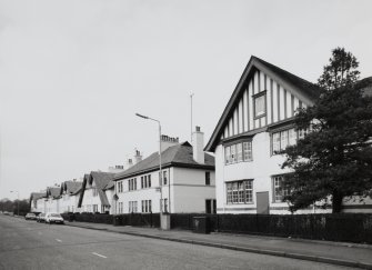 View from ESE down N side of Falside Road, showing houses associated with factory