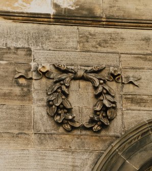 Detail of carved wreath on E facade.