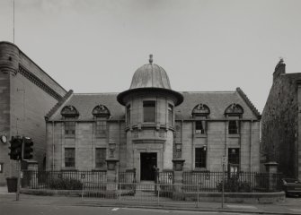 Exterior view from SW of baths, showing frontage, railings and plaque facing Inchinnan Road