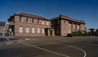 View of west wing and central block from SW.