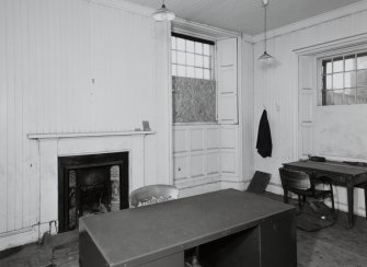 Interior.
View of office, showing fireplace and tongued and grooved wood panels and shutters.