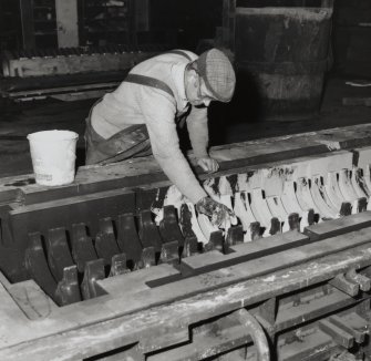 Detail of "cage" mould being coated by Alex Mackenzie, as part of preparation process