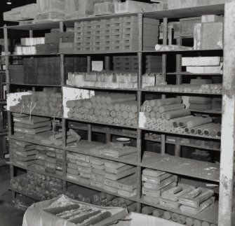 Detail of shelves of stores containing shell cores for moulds