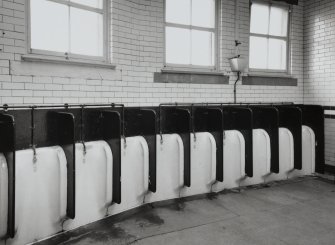 Interior.
View of arc of fireclay stall urinals in Gentlemen's toilets.