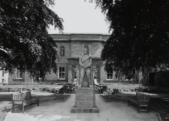 View from W of statue and front elevation.
