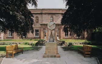 View from W of statue and front elevation.