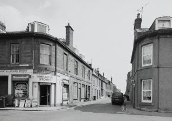 View from W showing corner shop in High Street.