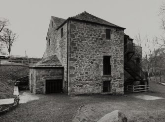 General view from SW with water wheel under extension.
