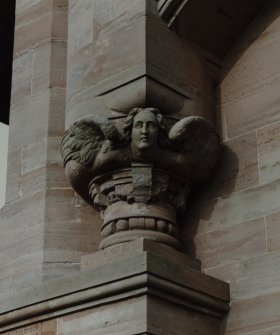 Detail of carved angel on S facade.