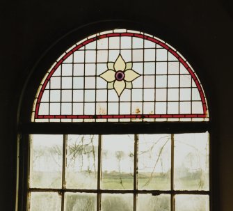 Interior.
Detail of stained glass window on S wall.