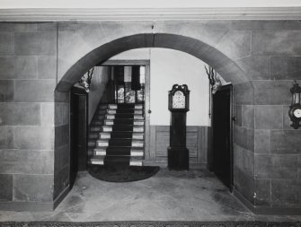Interior.
View of segmental arched opening on ground floor and stair from entrance hall.