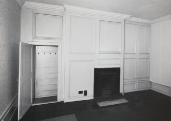Interior.
View of panelling on W wall of NE apartment on second floor.