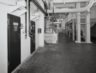 Kilns:  view from N at level beneath kiln floors, showing access doors to Kilns 2 and 3 (left), and the base of the malt bins (right).  The kilns are fired by oil burners directly, but two have a steam-heated indirect heat facility