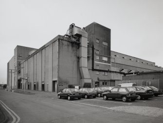 Exterior general view from NNE of maltings, showing brick-built block of five kilns (left), and silos (far left), with the Drum House (right), which contains 24 steeps and 24 drums