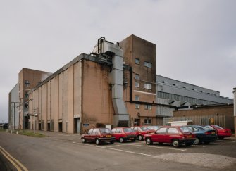 Exterior general view from NNE of maltings, showing brick-built block of five kilns (left), and silos (far left), with the Drum House (right), which contains 24 steeps and 24 drums