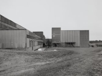 Exterior view from W along S side of Drum House of maltings