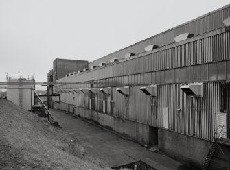 Exterior view from NW along N side of Drum House of maltings