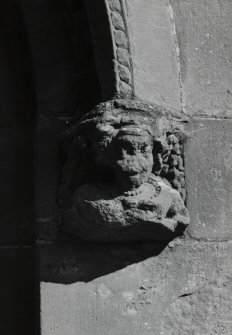 Detail of corbel on hoodmould above main entrance.