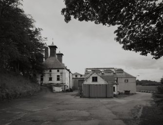 General view from E of kilns and block containing still house, tun room and mash house.