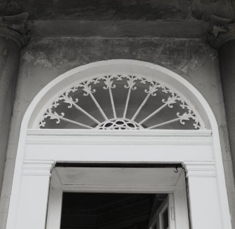 Detail of main doorway showing upper shafts of pilasters, entablature and fanlight.