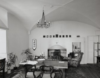 Interior.  Basement floor, view of vaulted chamber with replacement art nouveau fireplace.