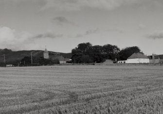 Distant view from S showing church and school.