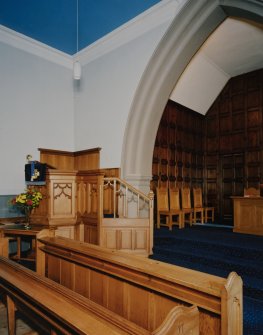 Interior.
View of Chancel from W showing the pulpit and reused panelling.