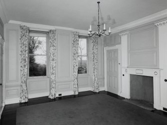 Interior. Ground floor View of drawing room from SE showing 18th century paneling, giant pilasters and early 19th century fireplace
