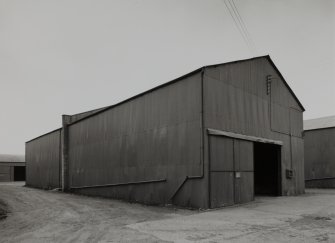 View from W of typical steel-framed corrugated-sheet-metal clad jute warehouse.