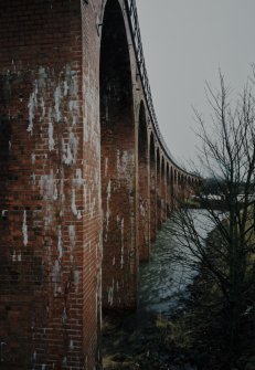 Oblique view from SE along E side of viaduct, showing detail of red brickwork