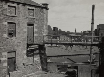 View of wrought iron walkway between blocks.