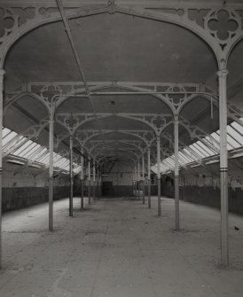 Top Floor (4th Flat):  Interior view from N down centre of central portion of mill, showing ornate cast-iron roof trusses with gothic tracery and quatrefoil columns