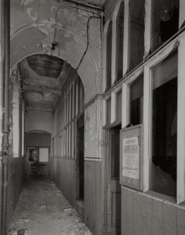 First Floor (2nd Flat):  Interior view from S along corridor adjacent to steam- engine house (right), showing health and safety notice (concerning dangers of un-tied long hair), and glazed round-arched panelling