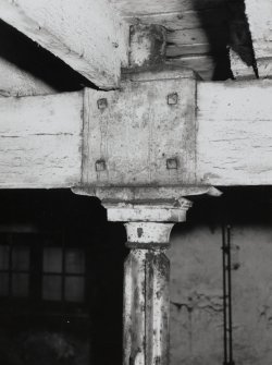 Exchange Street building. Interior.
Detail on second floor, West half of block, showing head of typical flanged column. Columns are 0.12m dia at 3.25m centres, having cast-iron saddles on top for wooden beams. Base of column from floor above is visible.