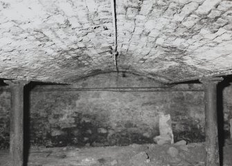 Exchange Street Building. Interior.
View of West half of basement from North-East with three bays of brick vaulting. Round cast-iron columns are 0.18m dia and 1.85m high at 3.3m centres, cast-iron beams bottom flange is 0.2m wide. Depth of arch is 0.38m. Flagstone floor.