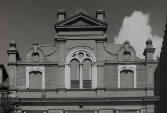 Detail of pediment at third floor level.