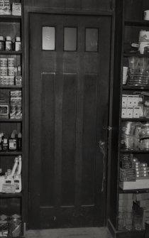 Interior view of 1 Dunira Street, Comrie, showing panelling in counter in the shop of Brough and Macpherson.