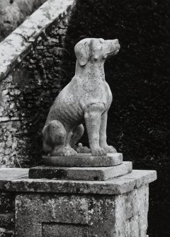 Detail of statue of dog at foot of stone stair (no.2 on plan), from West.