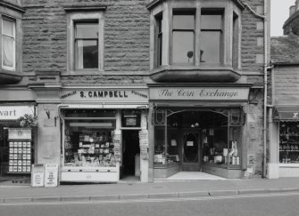 View of shopfronts of Nos. 19 and 21 from SSE