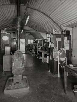 Interior view of workshop / range store (hut 7), showing an original pot bellied stove