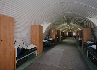 Interior view of R & F accommodation hut (hut 63) showing beds and wardrobes